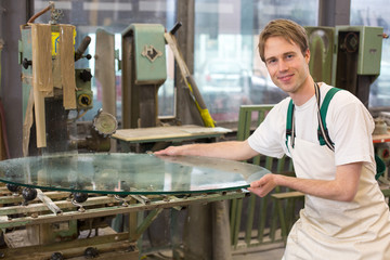 Glazier grinding a pieco of glass