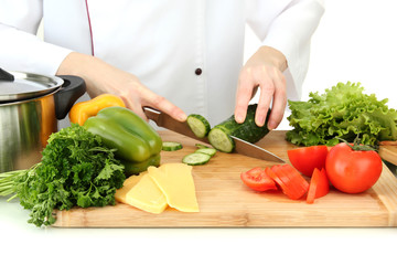 Female hands cutting vegetables, isolated on white