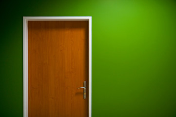 Wooden door on green background