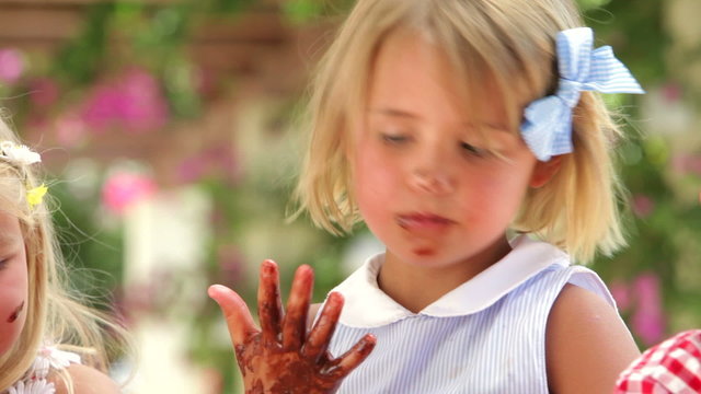 Girl Licking Melted Chocolate From Fingers