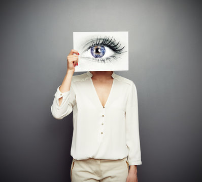 woman covering image with big eye