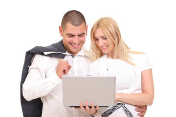 Happy man and woman looking at something on the laptop