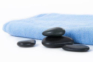 Massage Stones and Blue Towel