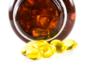 Capsules of fish oil spilled from bottle