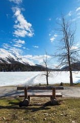 beautiful mountain landscape, lake ice, wooden bench