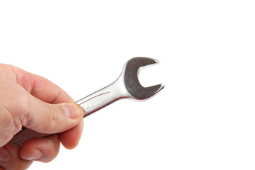 Hand holds a wrench isolated on white background.