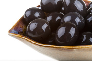 Olives black watered with olive oil in a bowl isolated on a whit