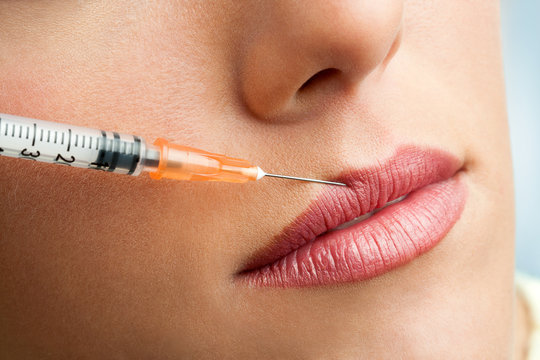 Macro syringe injection on female lips