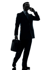 business man walking on the telephone silhouette