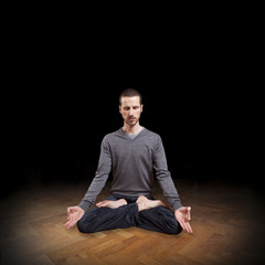 young man meditating in yoga position, meditation