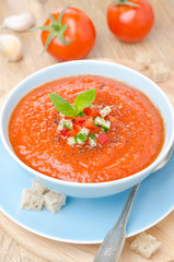 cold tomato soup gazpacho with basil in a bowl top view vertical