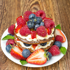Pancake cake with whipped cream and fresh berries