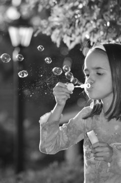 Little Hispanic Girl Blowing Bubbles