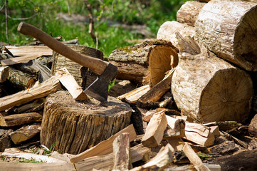 Axe and wooden log pieces