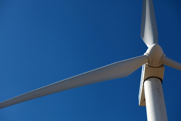Wind mill, a turbine close against blue sky