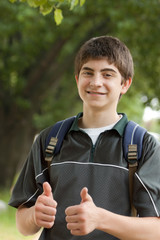 Teen boy student giving thumbs up