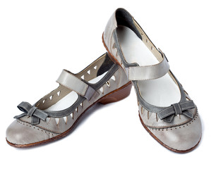Female shoes without and with heel on a white background..
