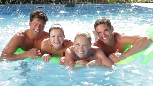 Group Of Friends Having Fun In Swimming Pool Together