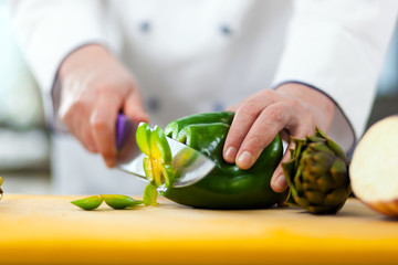 Chef cutting a pepper