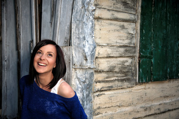 pretty young girl in front of old house