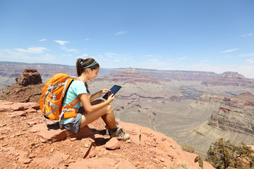 Tablet computer woman hiking in Grand Canyon