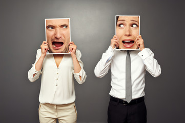 man and woman holding screaming faces