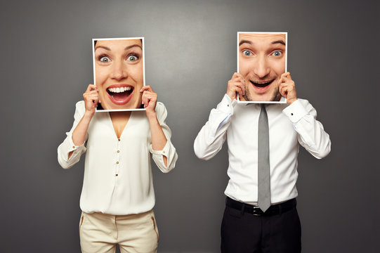 man and woman holding amazed happy faces