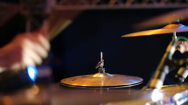 Rock band performing in a nightclub. Close-up of drummer
