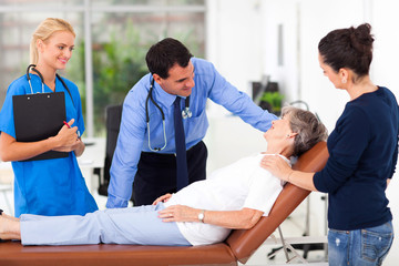 male doctor talking to senior patient