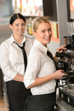 Smiling young waitresses serving coffee restaurant