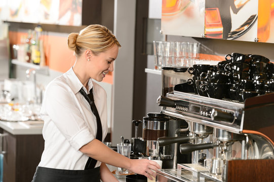 Waitress preparing hot beverage in coffee house