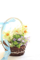 Fototapeta na wymiar artificiate flower in bamboo basket on white background