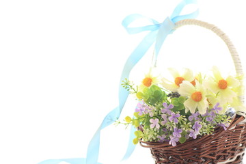 artificiate flower in bamboo basket on white background
