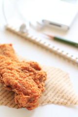 Fried chicken with stationery and note book on backgrouod