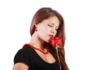 Pensive beautiful woman looks at red rose isolated on white