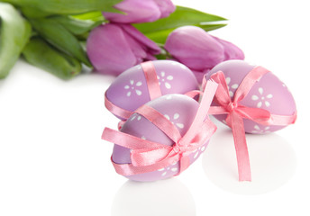 Bright easter eggs and tulips, isolated on white