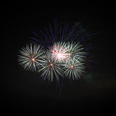 Group firework style explode on night sky.