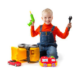 Little boy repairs toy car