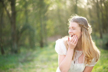 Portrait of a beautiful young woman laughing outdoors