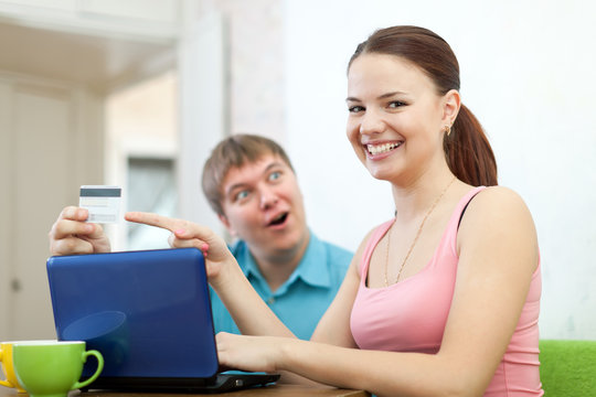 happy couple doing shopping in internet