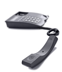 Black telephone on white with space for text