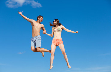 Happy Young Couple Together On The Beach