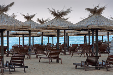 Lounge chairs with a sun canopy on the beach.