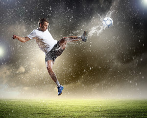 Naklejka na ściany i meble football player striking the ball