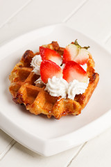 belgian waffles with fresh strawberries and whipped cream