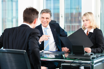 Business - young man sitting in job Interview