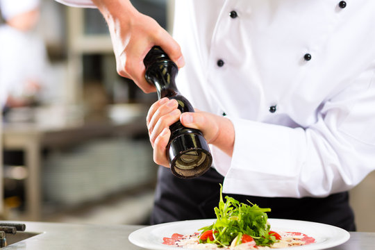 Chef in hotel or restaurant kitchen cooking