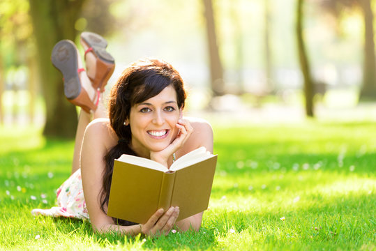 Romantic woman reading book in summer