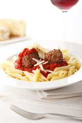 Italian meatballs with penne pasta in tomato sauce