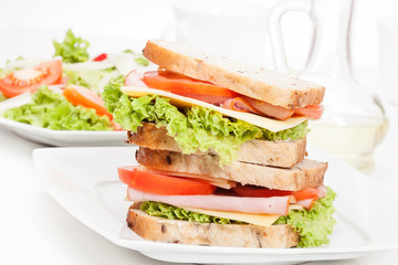 Ham and cheese sandwiches on plate